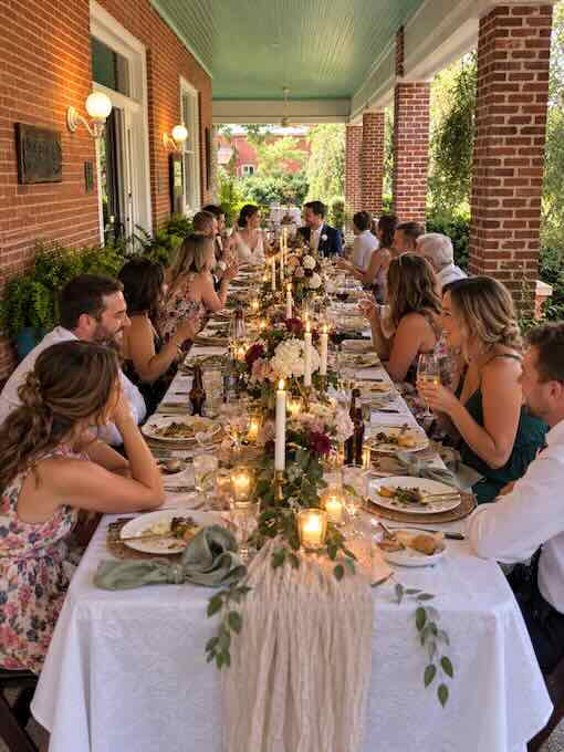 wedding guests dining on the front porch